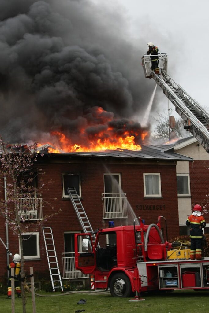 Dramatic scene of firefighters combating a raging fire on a building rooftop.